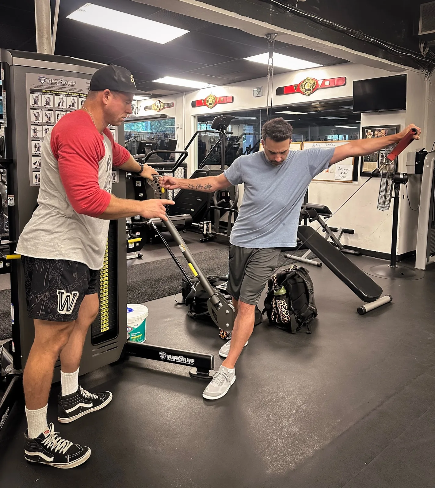 Alex Myers coaching a client through a cable exercise in Westlake Village